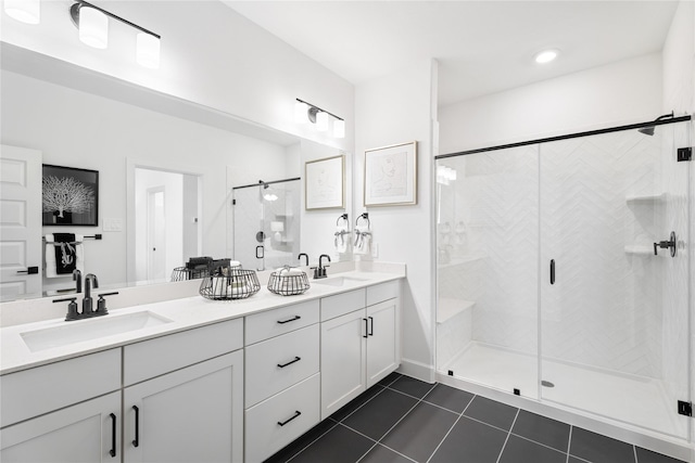 bathroom with vanity, a shower with door, and tile patterned floors