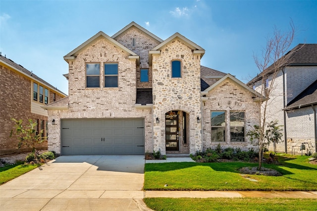 view of front of property with a front yard and a garage