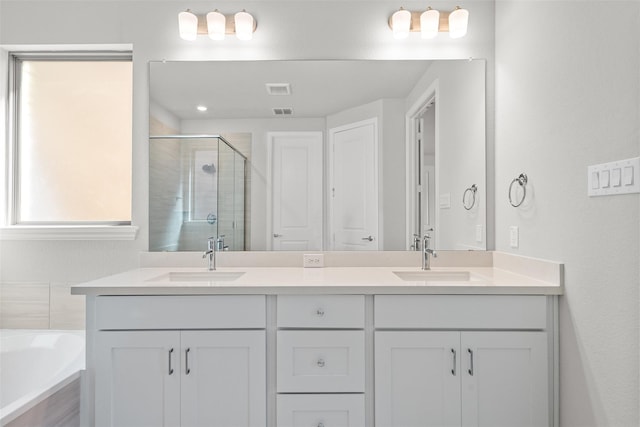 bathroom with vanity and independent shower and bath