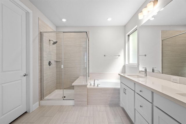 bathroom with shower with separate bathtub and vanity