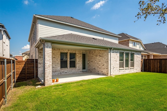 back of house featuring a lawn and a patio