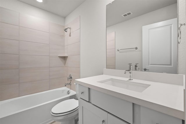 full bathroom featuring vanity, toilet, and tiled shower / bath combo