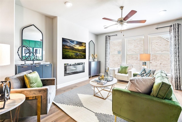 living room with light hardwood / wood-style flooring and ceiling fan