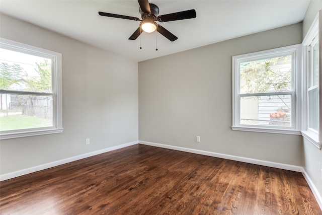 unfurnished room featuring dark hardwood / wood-style floors, plenty of natural light, and ceiling fan