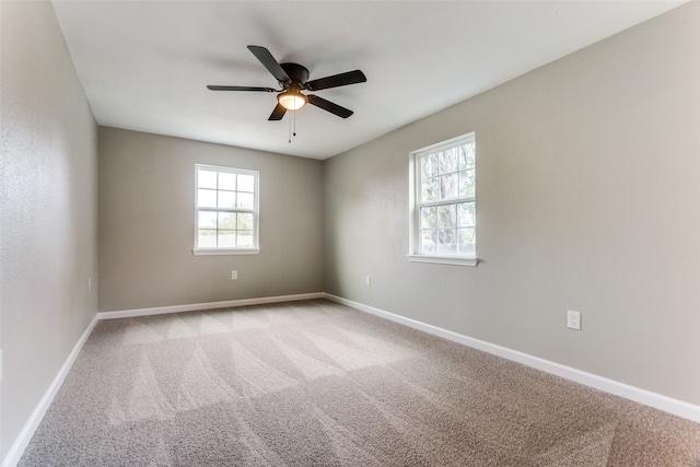 carpeted spare room with ceiling fan