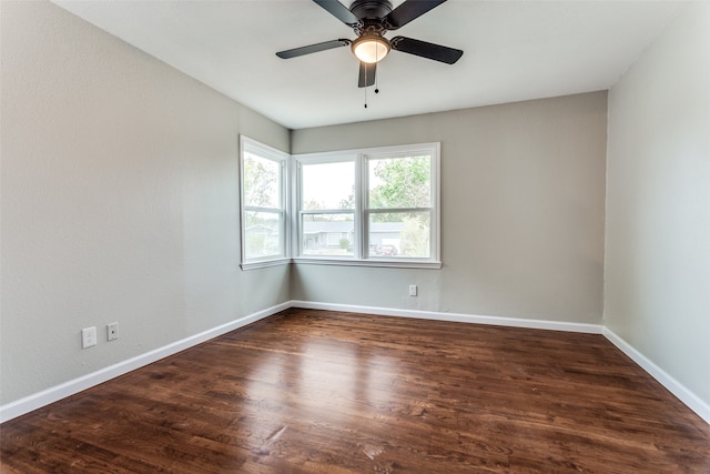 empty room with ceiling fan and dark wood-type flooring