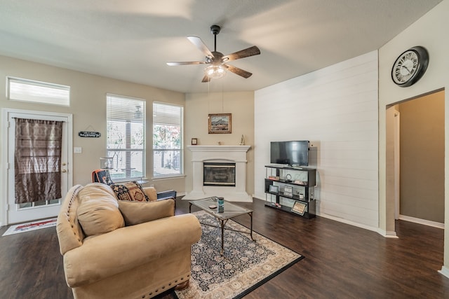 living room featuring dark hardwood / wood-style floors and ceiling fan