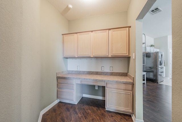 unfurnished office featuring dark hardwood / wood-style flooring and built in desk