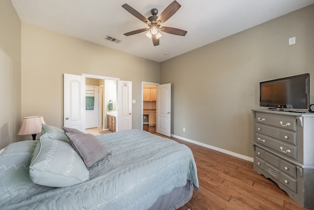 bedroom featuring connected bathroom, ceiling fan, and light hardwood / wood-style flooring