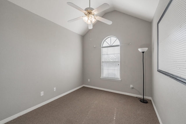 carpeted spare room featuring vaulted ceiling and ceiling fan