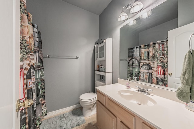 bathroom with tile patterned floors, toilet, and vanity