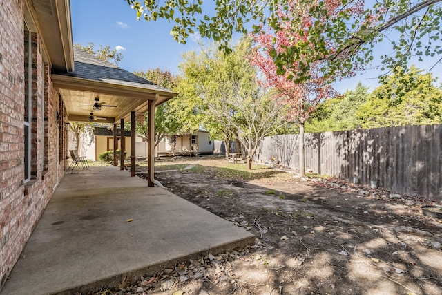 view of yard with a patio area, ceiling fan, and a storage unit