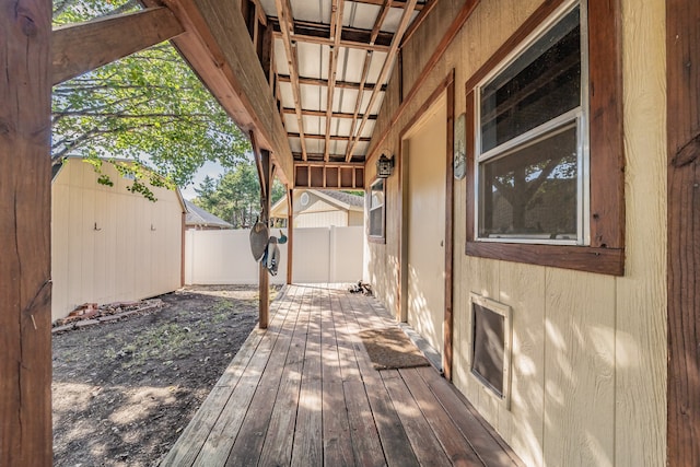 wooden deck featuring a storage shed