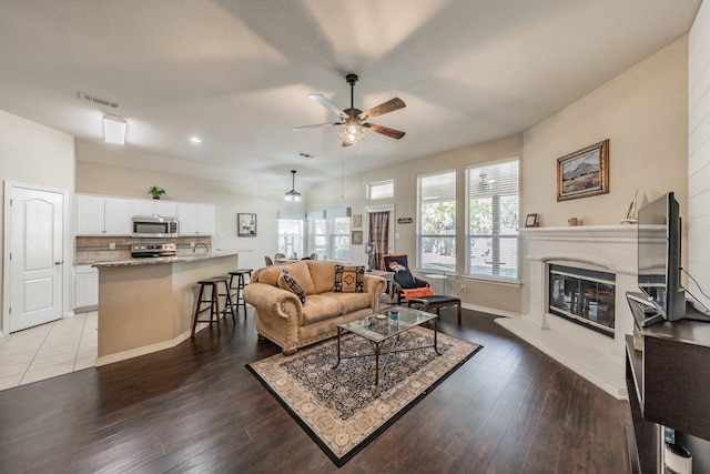 living room with wood-type flooring and ceiling fan