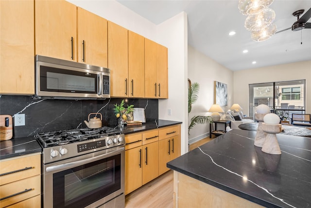 kitchen featuring tasteful backsplash, appliances with stainless steel finishes, light brown cabinets, and light wood-type flooring