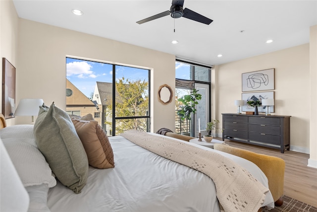 bedroom with ceiling fan and light hardwood / wood-style floors