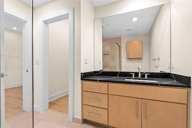 bathroom with vanity, tile patterned floors, and a shower with shower door