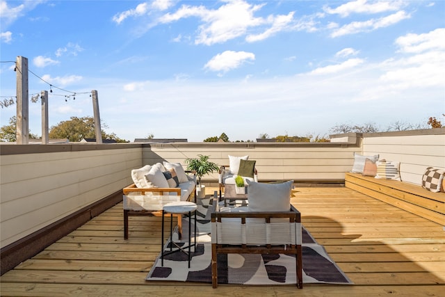 wooden terrace with an outdoor hangout area