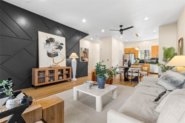 living room with ceiling fan and light wood-type flooring