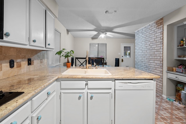 kitchen featuring ceiling fan, dishwasher, sink, kitchen peninsula, and white cabinets