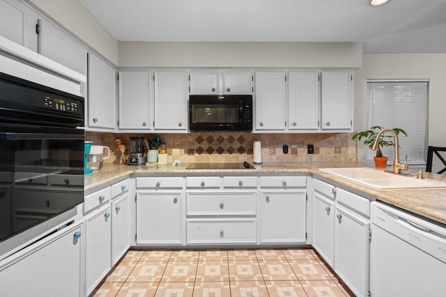 kitchen with backsplash, white cabinetry, sink, and black appliances