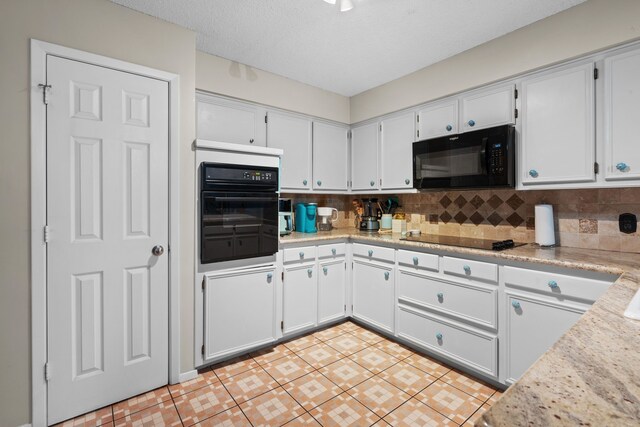 kitchen with light stone countertops, a textured ceiling, decorative backsplash, white cabinets, and black appliances