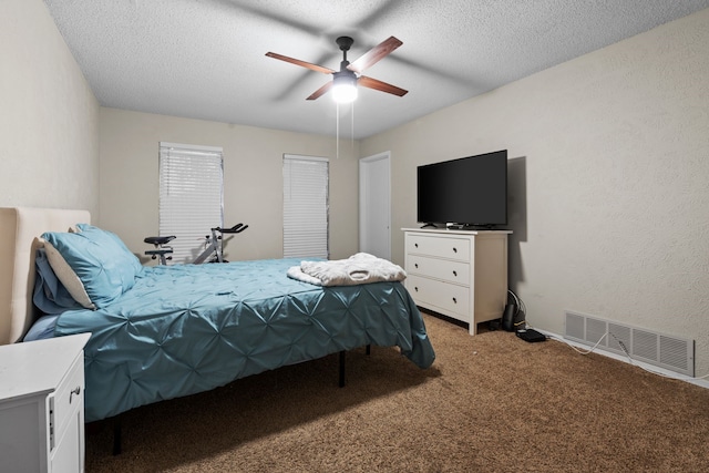 carpeted bedroom with a textured ceiling and ceiling fan