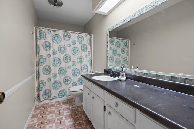 bathroom with tile patterned floors, curtained shower, vanity, and toilet