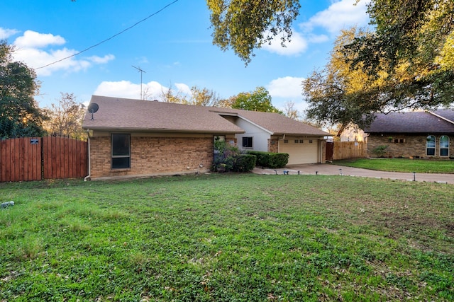 ranch-style home featuring a garage and a front yard