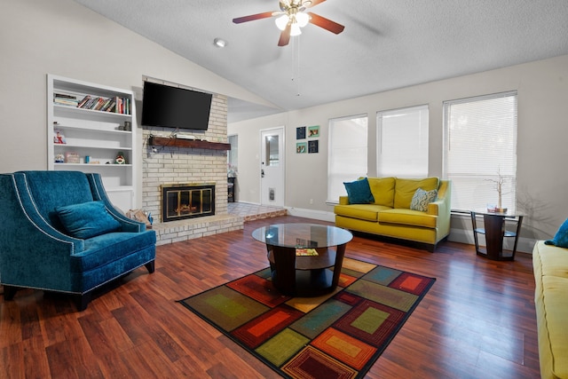 living room featuring a brick fireplace, a textured ceiling, dark hardwood / wood-style floors, and vaulted ceiling