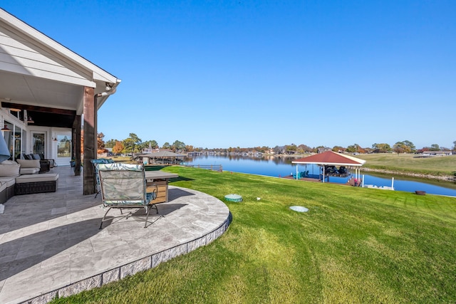 view of yard with a water view and a patio