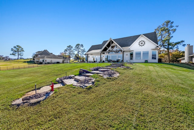 view of front of house featuring a front yard and fence