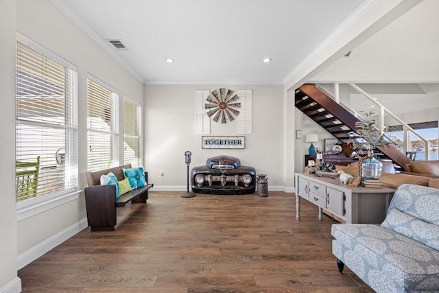 sitting room featuring wood finished floors, visible vents, baseboards, stairway, and crown molding