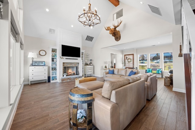 living room with dark wood-type flooring, a stone fireplace, visible vents, and high vaulted ceiling