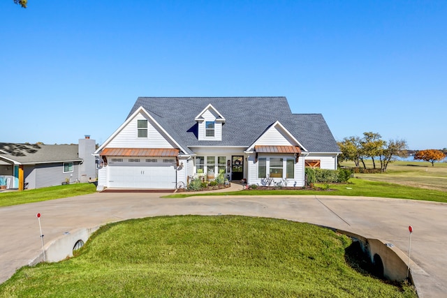 view of front of house featuring a garage and a front lawn