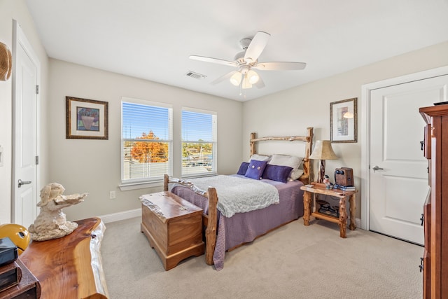 bedroom with light colored carpet, visible vents, ceiling fan, and baseboards