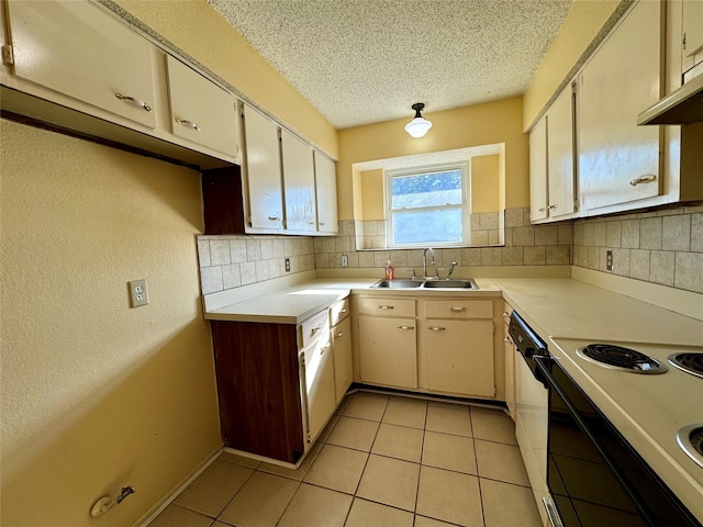 kitchen with dishwasher, electric stove, sink, decorative backsplash, and a textured ceiling