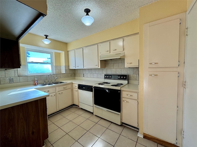 kitchen featuring white appliances, backsplash, white cabinets, sink, and light tile patterned floors