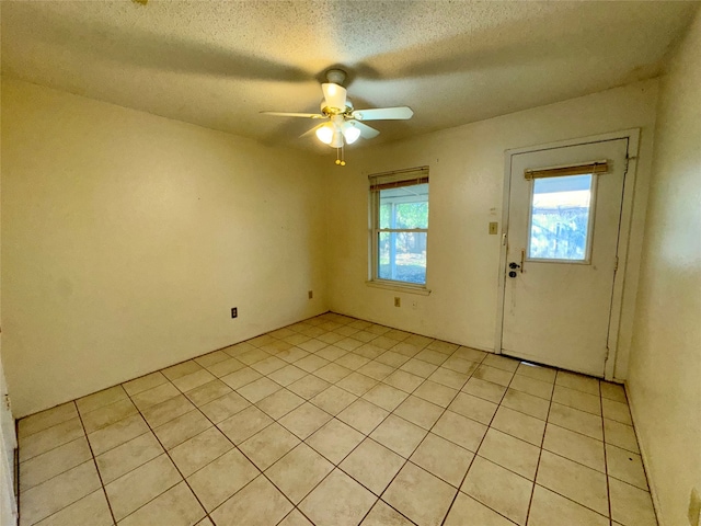 interior space featuring ceiling fan and a textured ceiling