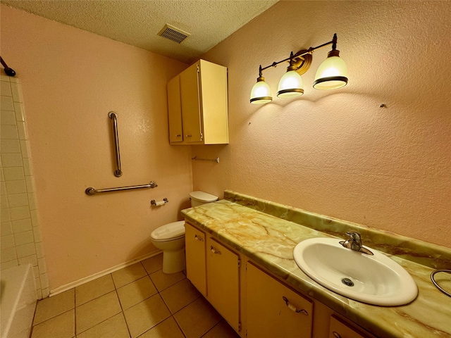 bathroom featuring tile patterned flooring, vanity, a textured ceiling, and toilet