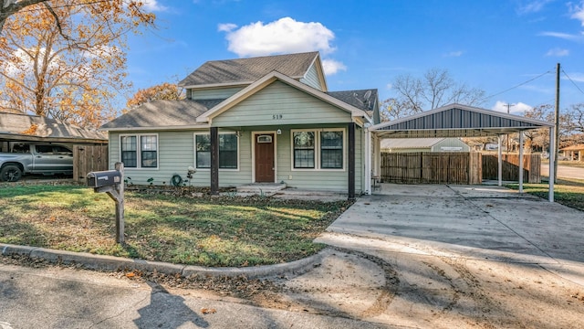 bungalow with covered porch and a front lawn