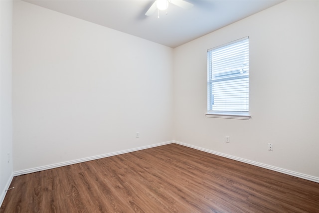 spare room with ceiling fan and dark hardwood / wood-style flooring