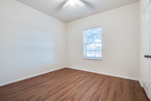 unfurnished room with ceiling fan and dark wood-type flooring