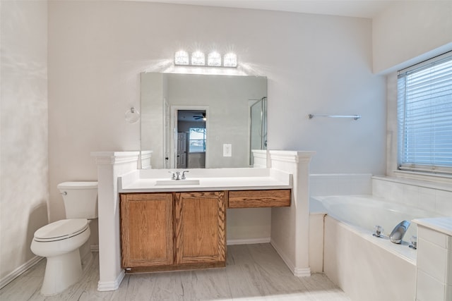 bathroom with a bathtub, toilet, and vanity