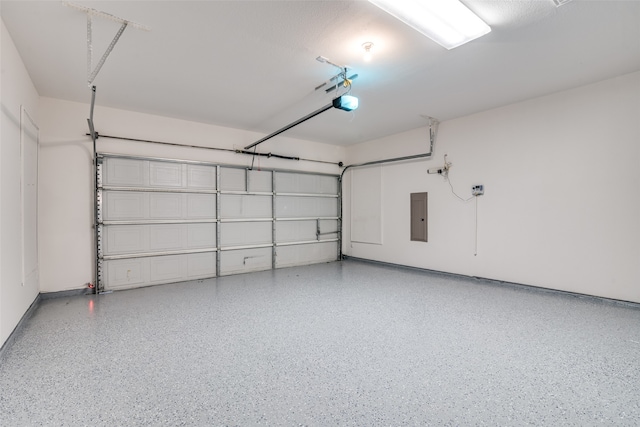 garage featuring electric panel and a garage door opener