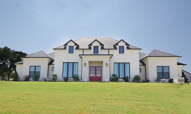 french country home featuring french doors and a front lawn