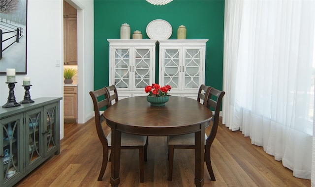 dining space featuring hardwood / wood-style floors and a notable chandelier