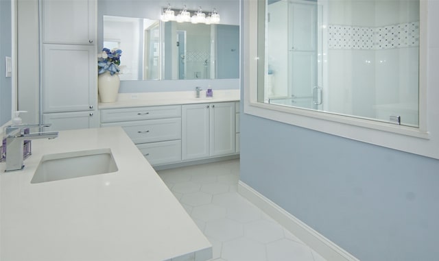 bathroom with tile patterned flooring, vanity, and a shower with shower door