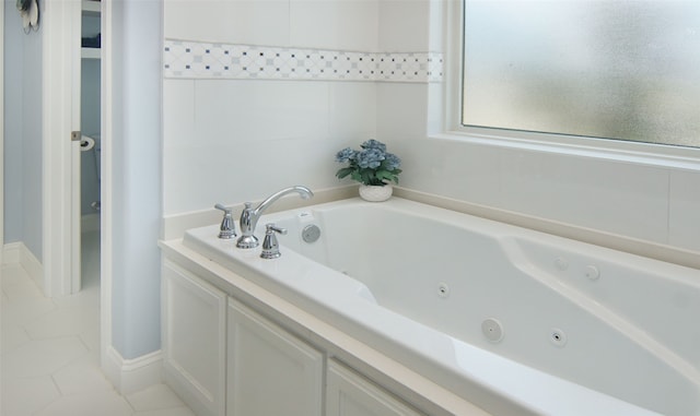 bathroom with a bathing tub and tile patterned flooring