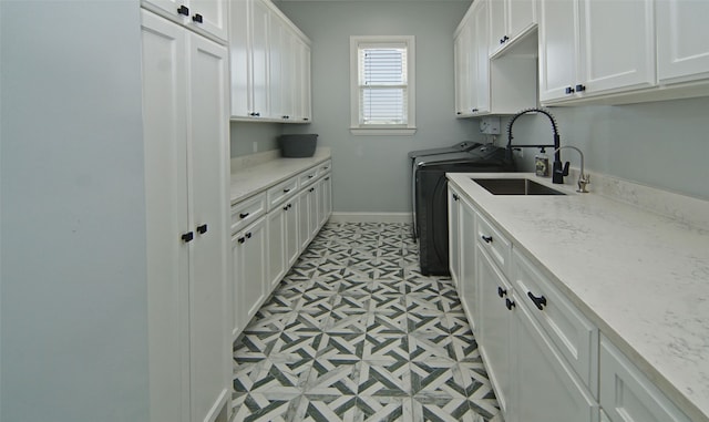 laundry area with cabinets, sink, and washing machine and clothes dryer